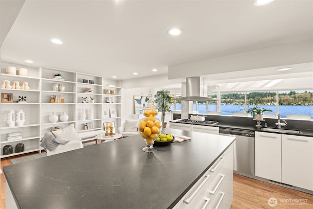 5438 E Mercer Way, Mercer Island, WA 98040 - kitchen featuring appliances with stainless steel finishes, island exhaust hood, light wood-style flooring, dark countertops, and recessed lighting