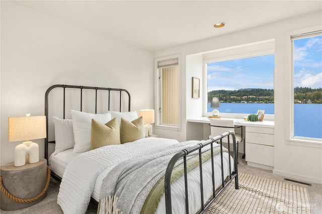 5438 E Mercer Way, Mercer Island, WA 98040 - bedroom featuring light colored carpet, multiple windows, recessed lighting, and a water view