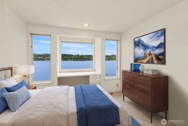 5438 E Mercer Way, Mercer Island, WA 98040 - bedroom with multiple windows, light carpet, recessed lighting, and a water view