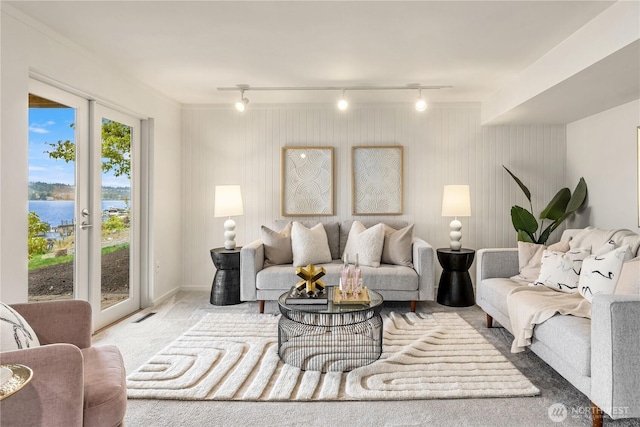 5438 E Mercer Way, Mercer Island, WA 98040 - carpeted living room featuring a water view and rail lighting