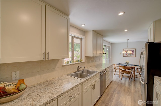 27521 U St, Ocean Park, WA 98640 - kitchen with stainless steel appliances, light countertops, light wood-style flooring, white cabinetry, and recessed lighting