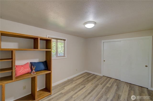 27521 U St, Ocean Park, WA 98640 - unfurnished bedroom with a textured ceiling, wood finished floors, and a closet