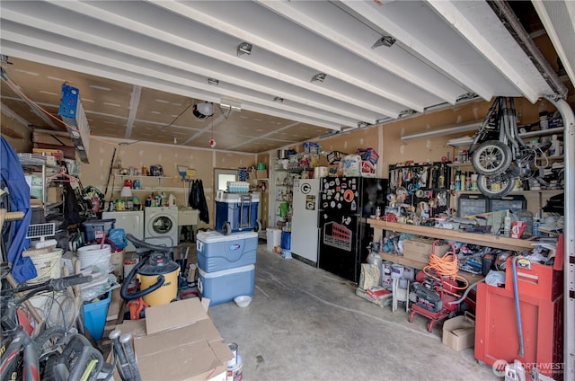 27521 U St, Ocean Park, WA 98640 - garage with washer and clothes dryer, a garage door opener, a workshop area, and freestanding refrigerator