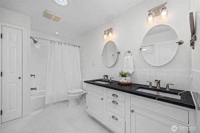 1424 E 36th Ln, Bellingham, WA 98226 - full bath with tile walls, double vanity, shower / bath combo with shower curtain, wainscoting, and recessed lighting