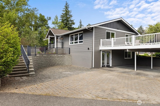 1424 E 36th Ln, Bellingham, WA 98226 - view of front of home with stairs, board and batten siding, a wooden deck, and driveway