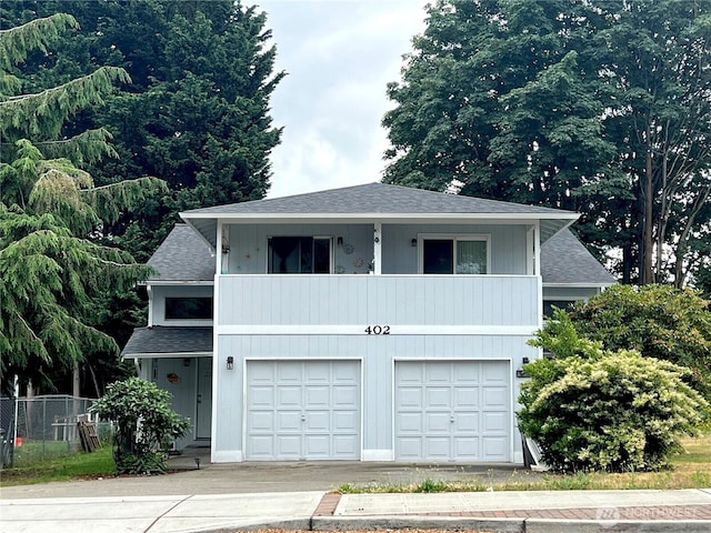 402 4th St SE, Auburn, WA 98002 - view of front of home featuring an attached garage, roof with shingles, driveway, and a balcony