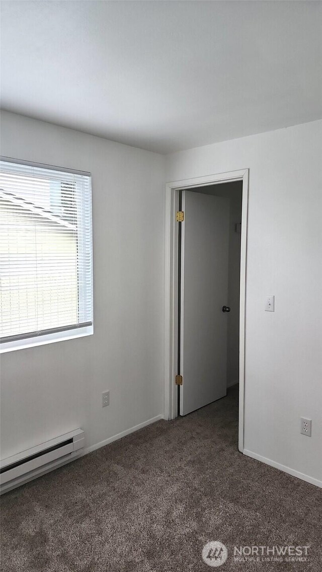 402 4th St SE, Auburn, WA 98002 - carpeted empty room with baseboard heating and baseboards