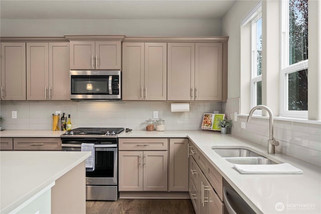 18611 134th St E, Bonney Lake, WA 98391 - kitchen featuring appliances with stainless steel finishes, light countertops, tasteful backsplash, dark wood-style flooring, and gray cabinets