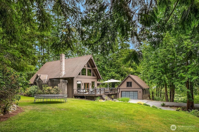 25112 SE 17th St, Sammamish, WA 98075 - chalet / cabin featuring a trampoline, a deck, a chimney, a front lawn, and a garage