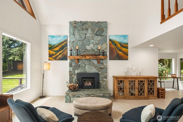 25112 SE 17th St, Sammamish, WA 98075 - tiled living area featuring high vaulted ceiling and a stone fireplace