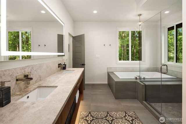 25112 SE 17th St, Sammamish, WA 98075 - bathroom featuring healthy amount of natural light, a garden tub, double vanity, tasteful backsplash, and recessed lighting