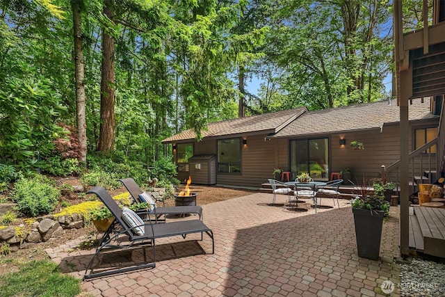 25112 SE 17th St, Sammamish, WA 98075 - view of patio with a fire pit and a storage shed