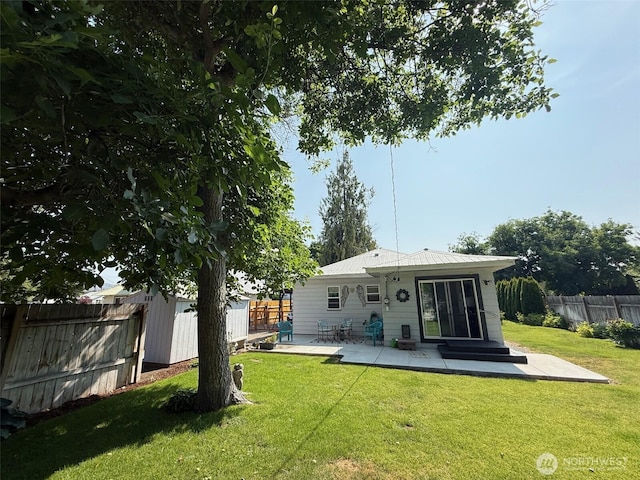 416 Cedar St S, Omak, WA 98841 - rear view of house featuring a patio area, a fenced backyard, and a metal roof