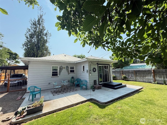 416 Cedar St S, Omak, WA 98841 - rear view of property featuring a fenced backyard, a patio area, and a metal roof