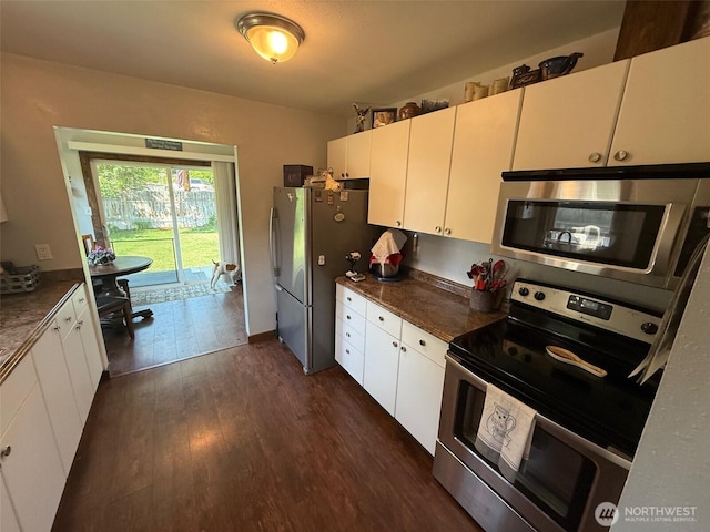 416 Cedar St S, Omak, WA 98841 - kitchen with appliances with stainless steel finishes, dark wood-type flooring, dark countertops, and white cabinetry