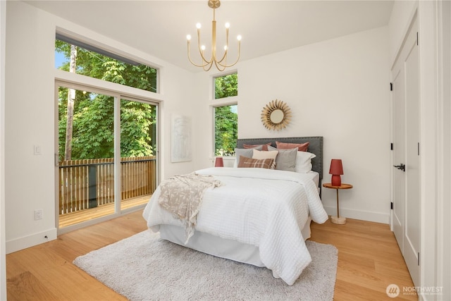 4615 2nd Ave NE, Seattle, WA 98105 - bedroom with access to exterior, a chandelier, and light wood finished floors