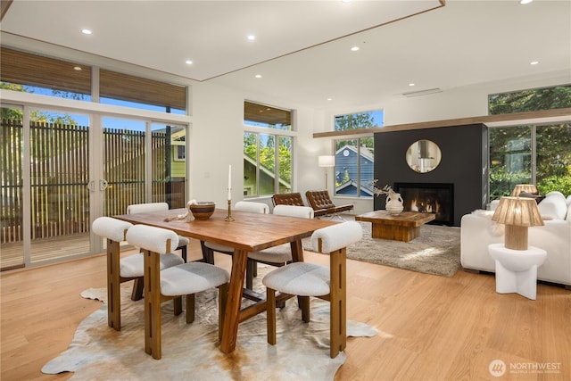 4615 2nd Ave NE, Seattle, WA 98105 - dining room featuring light wood-type flooring, a glass covered fireplace, and recessed lighting