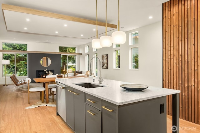 4615 2nd Ave NE, Seattle, WA 98105 - kitchen with light wood-type flooring, recessed lighting, an island with sink, open floor plan, and pendant lighting