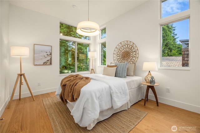 4615 2nd Ave NE, Seattle, WA 98105 - bedroom featuring light wood-style floors and a towering ceiling