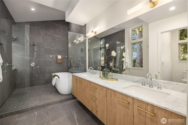 4615 2nd Ave NE, Seattle, WA 98105 - bathroom with a soaking tub, double vanity, walk in shower, marble tiled floors, and tile walls