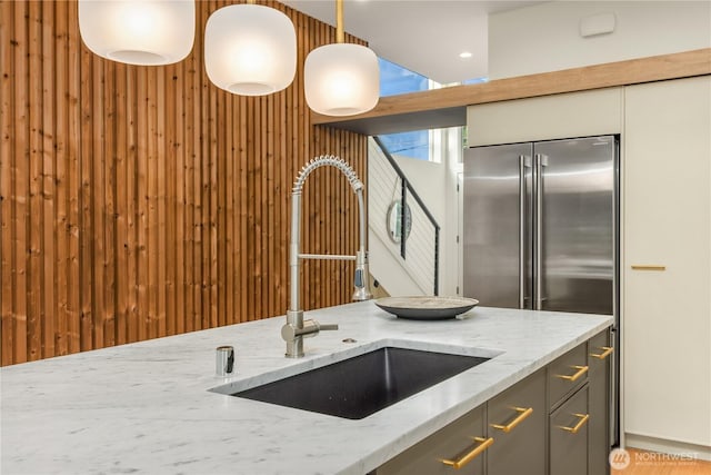 4615 2nd Ave NE, Seattle, WA 98105 - kitchen featuring light stone counters, decorative light fixtures, and gray cabinets