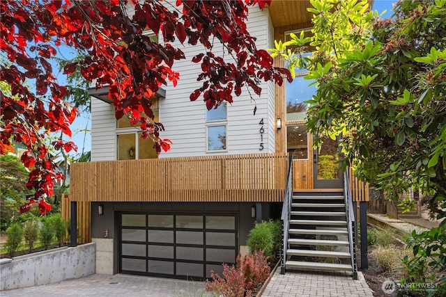 4615 2nd Ave NE, Seattle, WA 98105 - view of front of house with driveway, a garage, and stairway