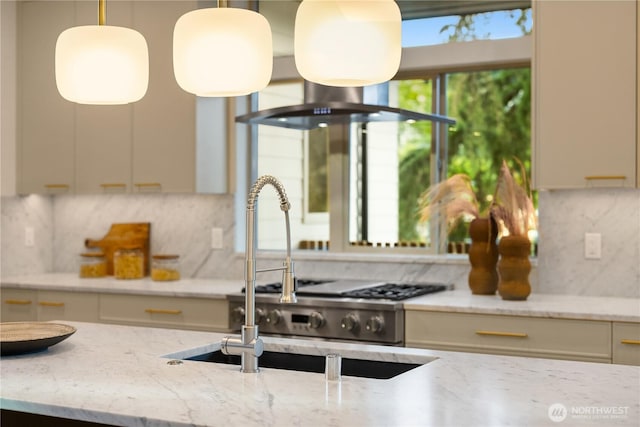 4615 2nd Ave NE, Seattle, WA 98105 - kitchen with backsplash, light stone counters, and decorative light fixtures