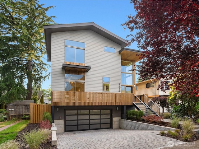 4615 2nd Ave NE, Seattle, WA 98105 - view of front facade with decorative driveway, an attached garage, and stairway