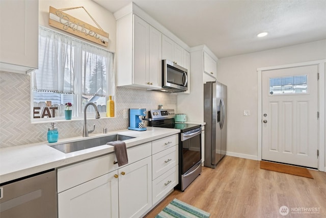 3628 S Sheridan Ave, Tacoma, WA 98418 - kitchen with appliances with stainless steel finishes, tasteful backsplash, white cabinetry, light countertops, and recessed lighting