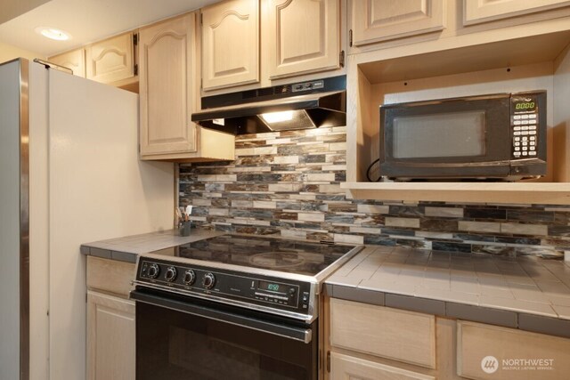8718 Dresden Ln SW, Lakewood, WA 98498 - kitchen with range with electric stovetop, black microwave, tile counters, and under cabinet range hood