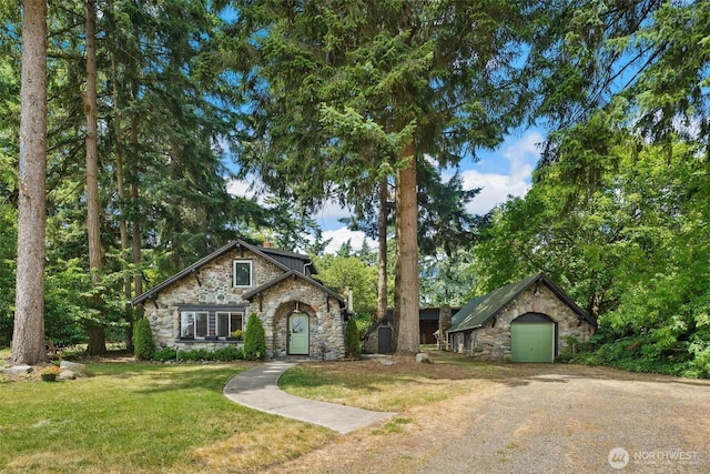 8038 S Ainsworth Ave, Tacoma, WA 98408 - view of front of property featuring stone siding, a front lawn, and driveway