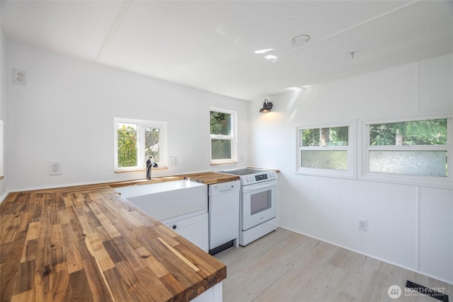 2500 Samish Way Unit 44, Bellingham, WA 98229 - kitchen featuring wood counters, white appliances, light wood-type flooring, and white cabinets