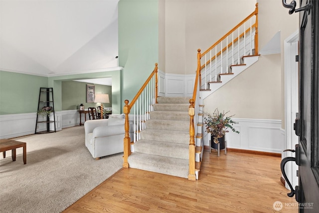 14809 283rd Pl NE, Duvall, WA 98019 - entryway with stairway, light wood-type flooring, high vaulted ceiling, a wainscoted wall, and a decorative wall