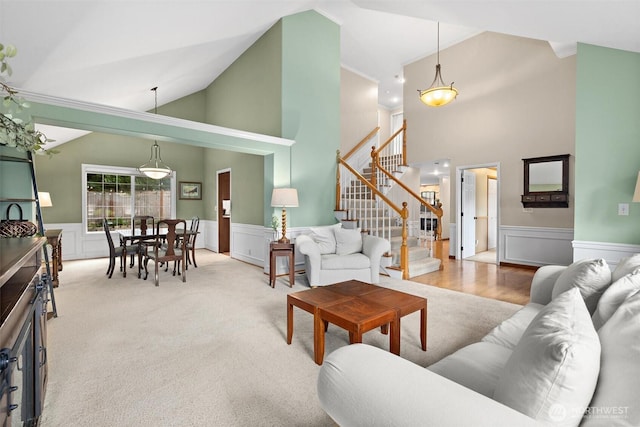 14809 283rd Pl NE, Duvall, WA 98019 - living area featuring wainscoting, stairway, high vaulted ceiling, crown molding, and carpet flooring
