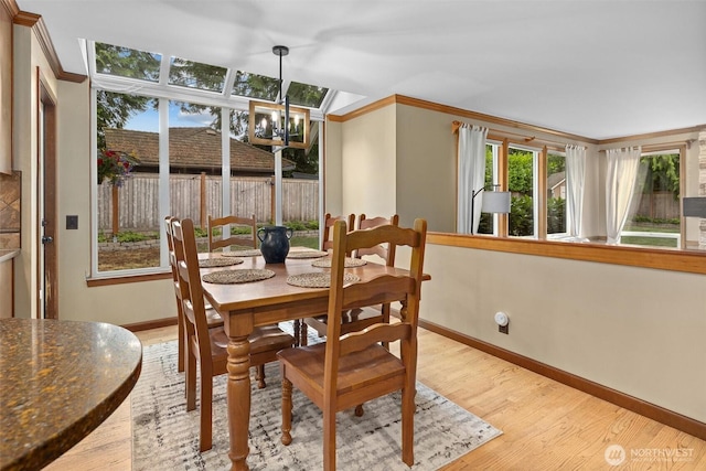 14809 283rd Pl NE, Duvall, WA 98019 - dining room with ornamental molding, light wood-style flooring, and a chandelier