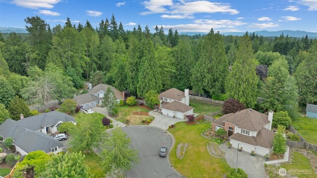 14809 283rd Pl NE, Duvall, WA 98019 - aerial view of residential area with a heavily wooded area and mountains