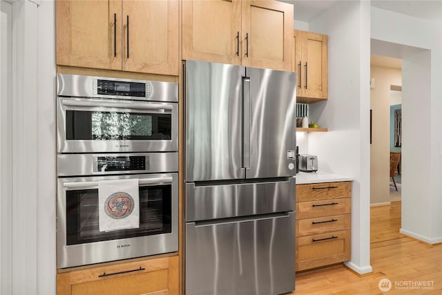 6703 Marshall Ave SE, Auburn, WA 98092 - kitchen with appliances with stainless steel finishes, light wood-type flooring, light countertops, and open shelves