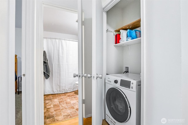 5720 122nd Ave SE Unit 179, Bellevue, WA 98006 - laundry room featuring washer / dryer and stone finish floors
