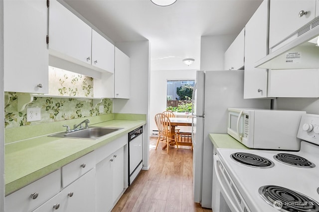 5720 122nd Ave SE Unit 179, Bellevue, WA 98006 - kitchen with white appliances, exhaust hood, light countertops, and light wood-style floors