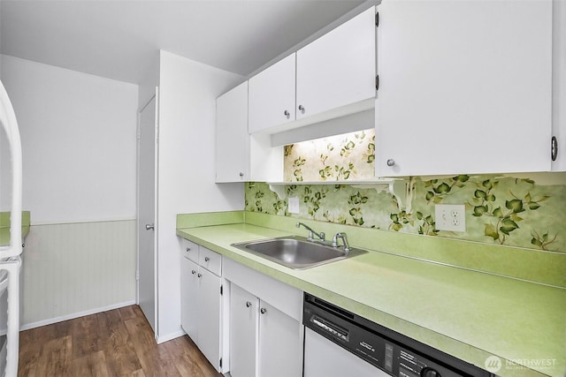 5720 122nd Ave SE Unit 179, Bellevue, WA 98006 - kitchen featuring white dishwasher, dark wood finished floors, light countertops, white cabinets, and wainscoting