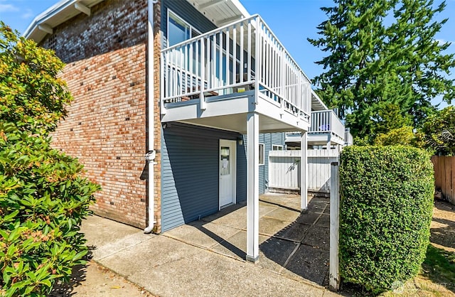 5720 122nd Ave SE Unit 179, Bellevue, WA 98006 - rear view of house featuring brick siding and a balcony