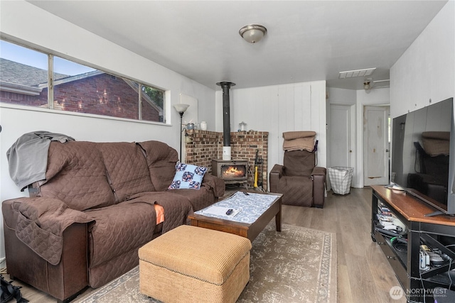 5221 S I St, Tacoma, WA 98408 - living area featuring light wood-type flooring, a wood stove, and plenty of natural light