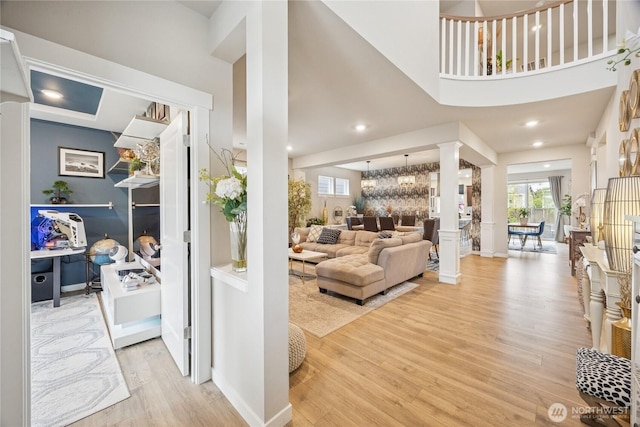 18437 111th Ave E, Puyallup, WA 98374 - living room featuring wood finished floors, plenty of natural light, ornate columns, recessed lighting, and a towering ceiling