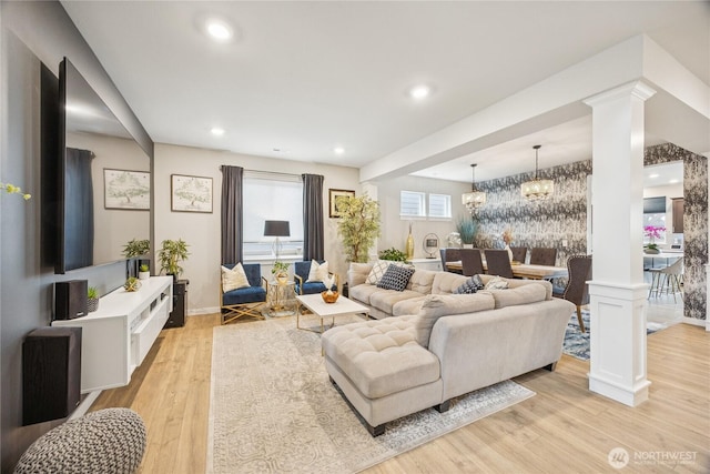 18437 111th Ave E, Puyallup, WA 98374 - living room with light wood-style flooring, a chandelier, decorative columns, and recessed lighting