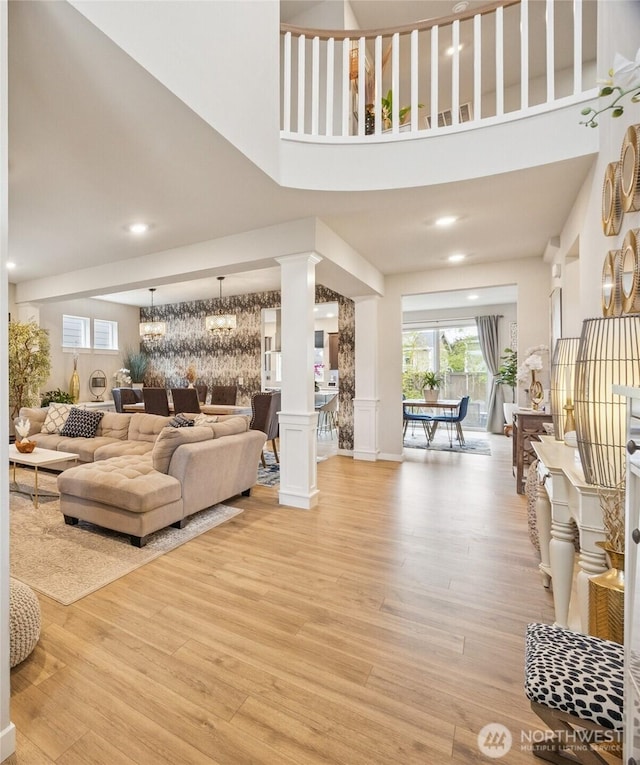 18437 111th Ave E, Puyallup, WA 98374 - living area with decorative columns, light wood-style floors, recessed lighting, and a towering ceiling