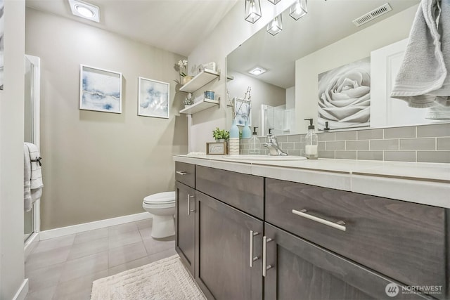 18437 111th Ave E, Puyallup, WA 98374 - full bathroom featuring vanity, backsplash, tile patterned floors, and a shower with shower door