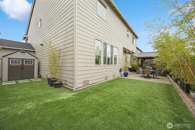 18437 111th Ave E, Puyallup, WA 98374 - back of house featuring a patio, a gazebo, a storage unit, and a fenced backyard