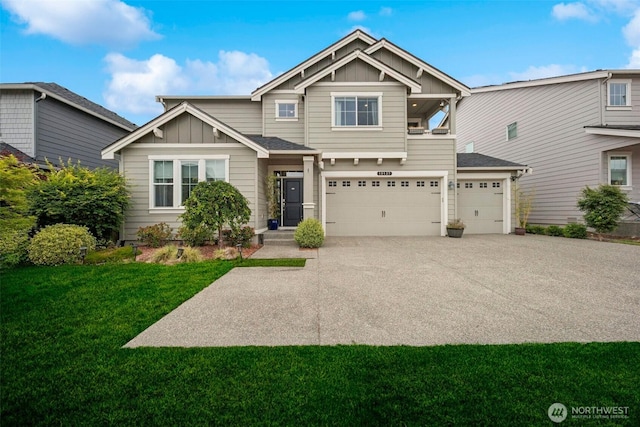 18437 111th Ave E, Puyallup, WA 98374 - view of front of property featuring board and batten siding, a front lawn, concrete driveway, and an attached garage