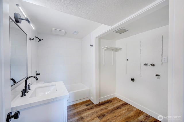 19807 80th Pl W, Edmonds, WA 98026 - full bathroom with vanity, wood finished floors, a textured ceiling, and bathtub / shower combination