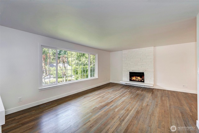 19807 80th Pl W, Edmonds, WA 98026 - unfurnished living room featuring wood finished floors and a stone fireplace